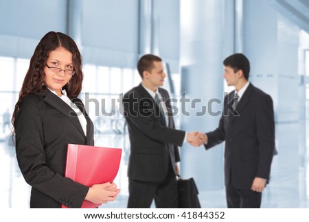 beautiful with  brown hair  woman with red folder and two young businessmen in business center, collage