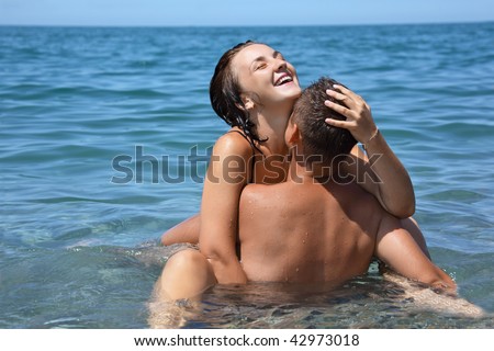 stock photo young hot woman sitting astride man in sea near coast 