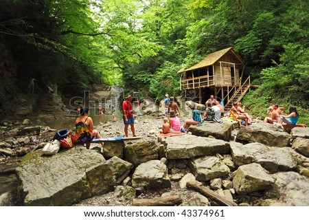 SOCHI, RUSSIA - JULY 15.  People near waterfall in Sochi, Russia. This year resorts of Big Sochi expect to have about 4.4 million vacationers, or about 400,000 more than in 2008. July 15, 2009