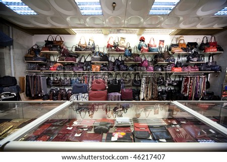 Bags, suitcases, purses and scarfs in shop of leather goods and accessories