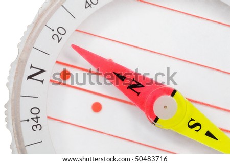 Fragment of plastic compass with an arrow specifying in north isolated on white background