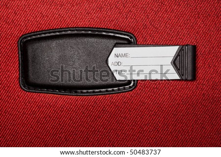 Label with identification data on red textural fabric