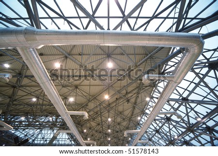 Roof of building from inside: extinguishing system and lighting. Frame of steel structures.