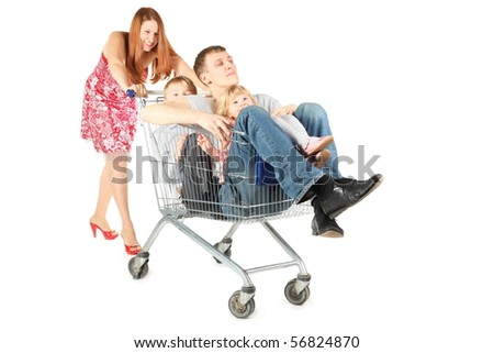 family with two children. father with son and daughter is sitting in shopping basket. woman is smiling. isolated.