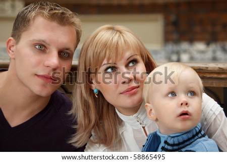Family of three people close up. Look to right.