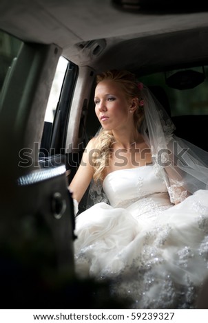stock photo Bride in wedding dress sits in limousine and looks out in 