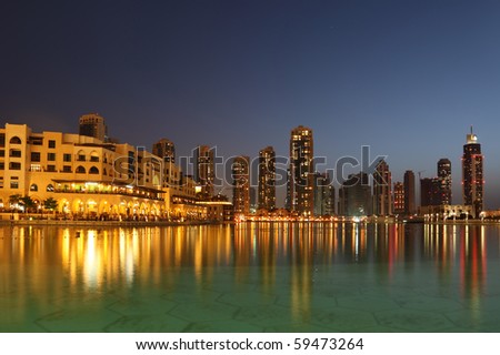 Dubai skyscrapers and other buildings at night time, view from water
