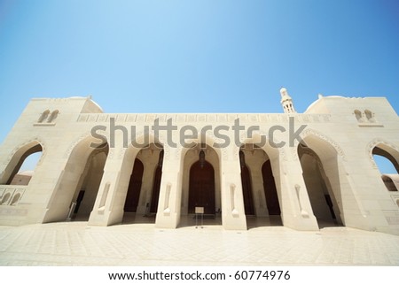 building with arcs and big doors of building inside Grand Mosque in Oman. Wide Angle.