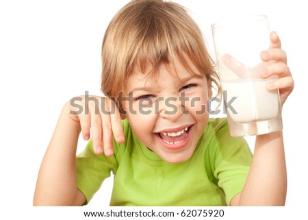 small girl in green blouse wriggles and drinks tasty fresh milk