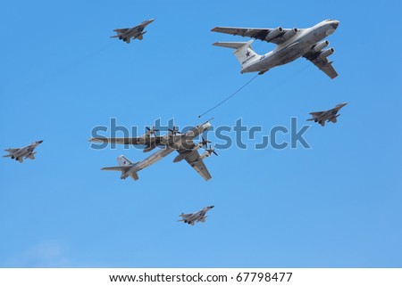 MOSCOW - MAY 9: Il-76 and Tu-95ms planes accompanied by group of fighters Mig-29 on parade in honor of Great Patriotic War victory on May 9, 2010 in Moscow, Russia.