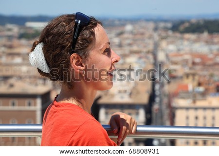 beautiful young woman looks at Rome from Altar of Fatherland in Rome, Italy.