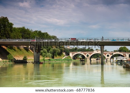 cars go over bridge on Tiber River, away bridge Trastevere in Rome, Italy