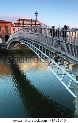 People going on Ha\'penny Bridge, Liffey River in Dublin, Ireland