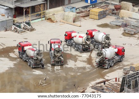 Concrete mixers, tractor and construction materials on big area