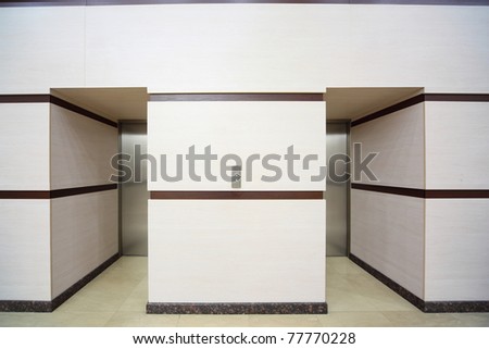 Two elevators with closed metallic doors