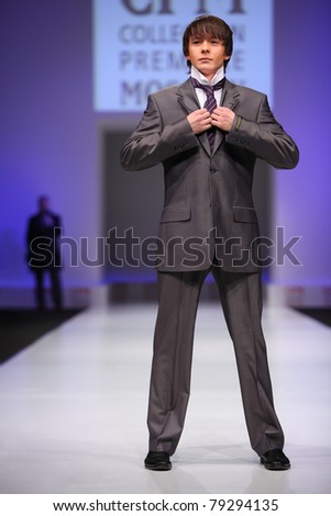 MOSCOW - FEBRUARY 22: A model wears a  gray suit from Slava Zaytzev and walks the catwalk in the Collection Premiere Moscow, leading fashion fair in Eastern European market, on February 22, 2011 in Moscow, Russia.