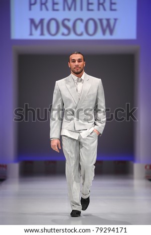 MOSCOW - FEBRUARY 22: A model wears a gray suit from Slava Zaytzev and walks the catwalk in the Collection Premiere Moscow, leading fashion fair in Eastern European market, on February 22, 2011 in Moscow, Russia.