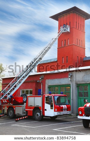 fire station, red fire truck with long ladder, red high tower