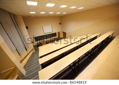 Classroom, university lecture hall; big blackboard, wooden desks and benches