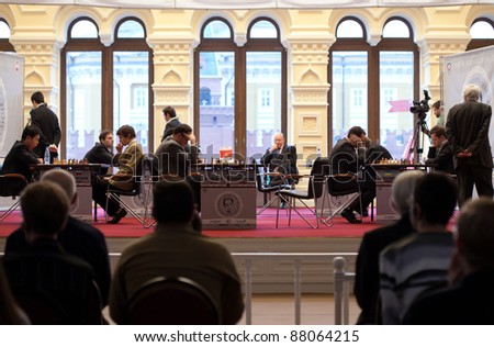 MOSCOW - NOVEMBER 4: People observe game of grand masters on Michael Tals Fifth chess memorial , November 4, 2010 in Moscow, Russia.
