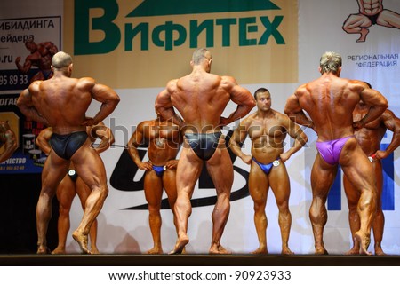 MOSCOW - APRIL 16: Three bodybuilders show their backs to the audience at Open Cup of bodybuilding and fitness of Moscow in hall at hotel Cosmos on April 16, 2011 in Moscow, Russia.