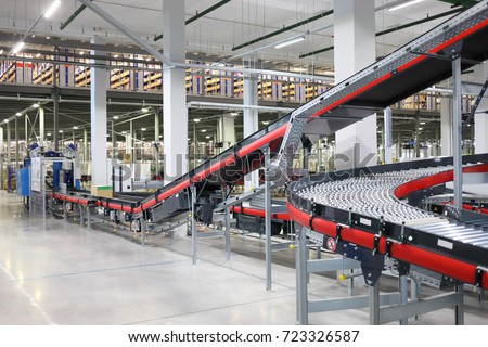 Big empty modern workshop with conveyors for sorting of goods