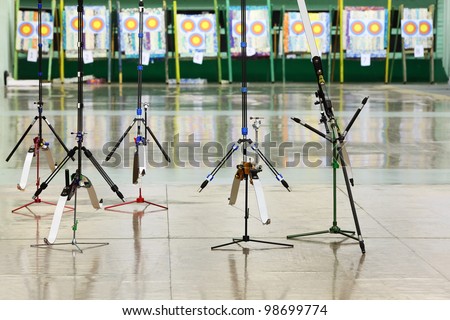 Five big sport bows stand on stilts inside shooting gallery