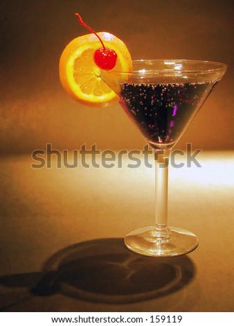 Cocktail glass with a slice of orange and a cherry...  tasted good too!