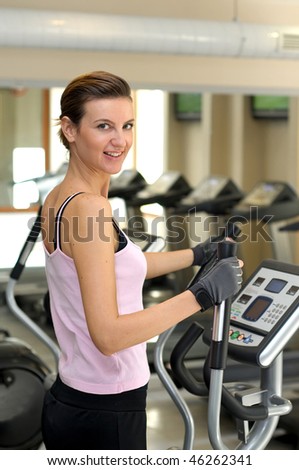 Young girl smiling and about to work out at the Gym