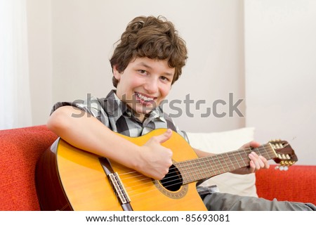 stock photo A preteen boy giving a thumbs up and a big happy smile as