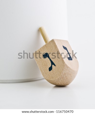 Small wood dreidel for Hanukkah on white background Small wood dreidel for Hanukkah on white background
