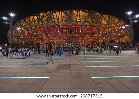 Beijing- October 11: Bird Nest (Beijing National Stadium). Chinese tourists walk at Square on October 11, 2009.