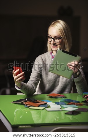 a young business woman is matching colors using her tablet