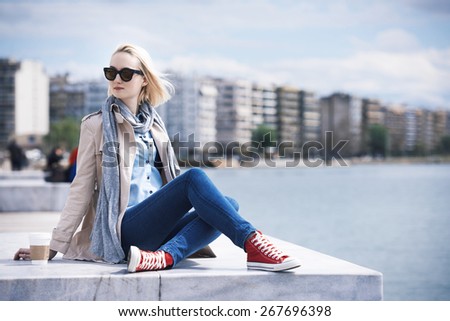 woman lounge by the sea in an urban environment