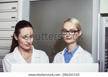 two women scientists in front of a computer screen