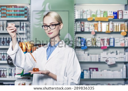 young woman scientist holding a test tube containing a chemical ingredient