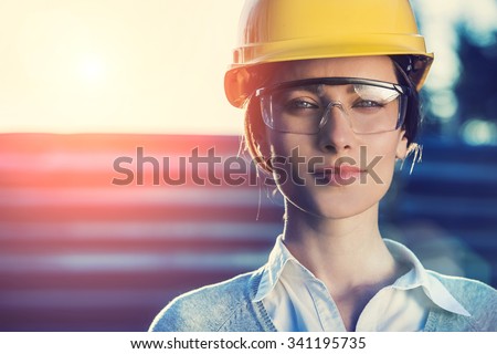 beautiful woman civil engineer close up portrait in front of a sunset background