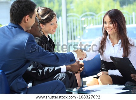 Happy smiling businesswoman shaking hands after a business meeting