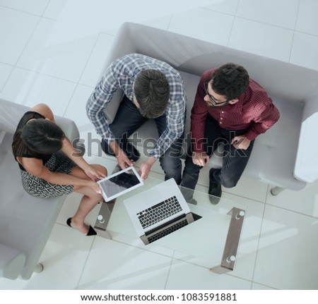 view from above of a group of people working with gadgets