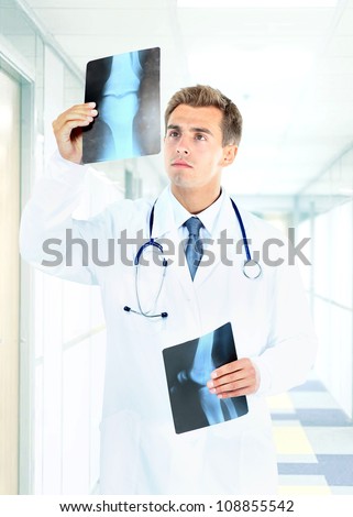 Happy doctor looking at x-ray