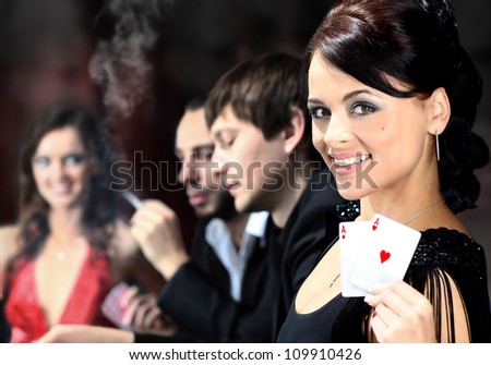 Poker players sitting around a table at a casino