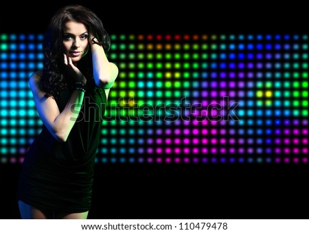 Fashion expressive girl dancing at disco light