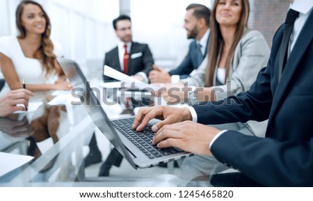 Businessman using laptop during a meeting of the Board of Directors