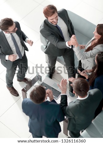 Happy successful business team giving a high fives gesture as th