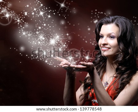 beautiful girl blowing magic stars