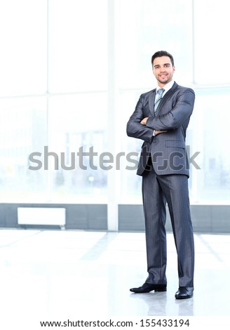 Full body portrait of young happy smiling cheerful business man