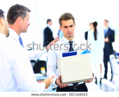 dismissed businessman carrying box