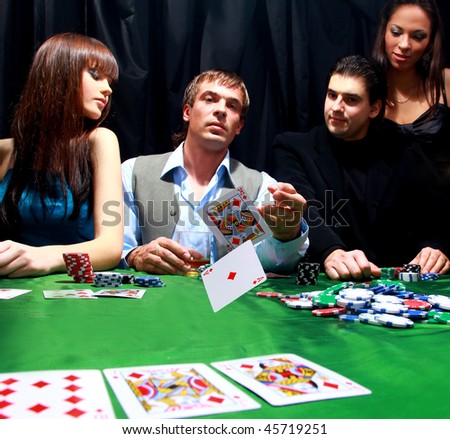 Stylish man in black suit folds two cards in casino poker at Las Vegas over black