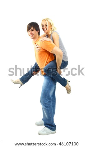 Happy young female enjoying a piggyback ride on boyfriends back against white