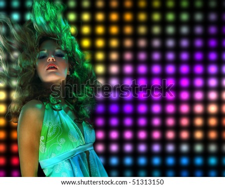 Beautiful young woman dancing in the nightclub